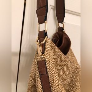 Brown leather handle tan straw hobo bag
